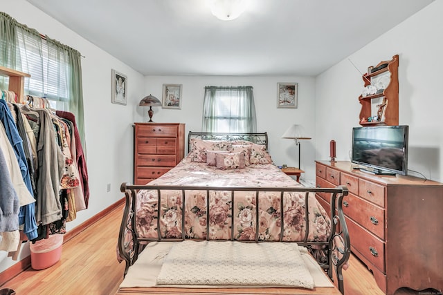 bedroom featuring light wood-type flooring and multiple windows