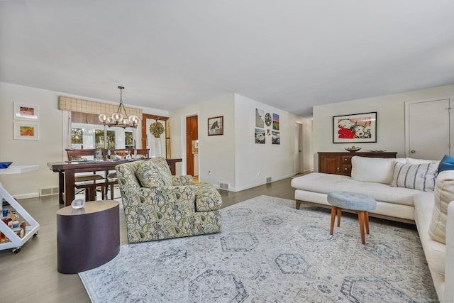 living room featuring hardwood / wood-style floors and a notable chandelier