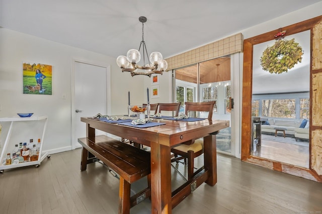 dining room featuring a notable chandelier, hardwood / wood-style flooring, and plenty of natural light