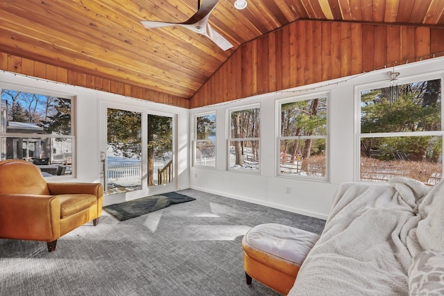 sunroom / solarium featuring ceiling fan, vaulted ceiling with skylight, and plenty of natural light