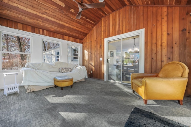 sunroom featuring ceiling fan with notable chandelier, lofted ceiling, and wood ceiling