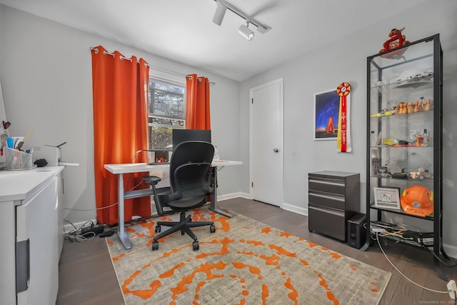 home office with track lighting and dark hardwood / wood-style floors