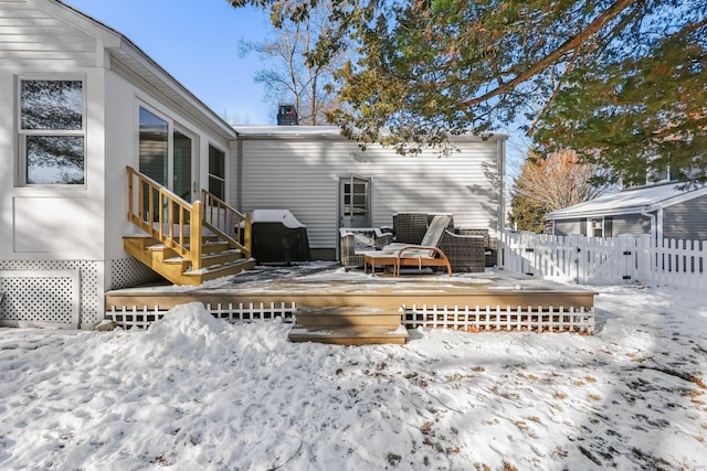 snow covered house featuring a deck