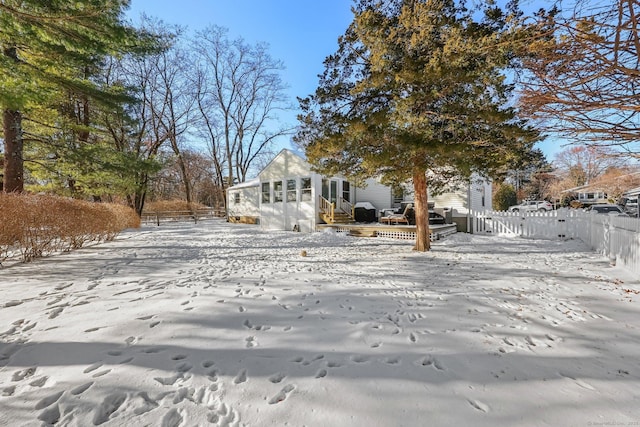 yard covered in snow with a deck