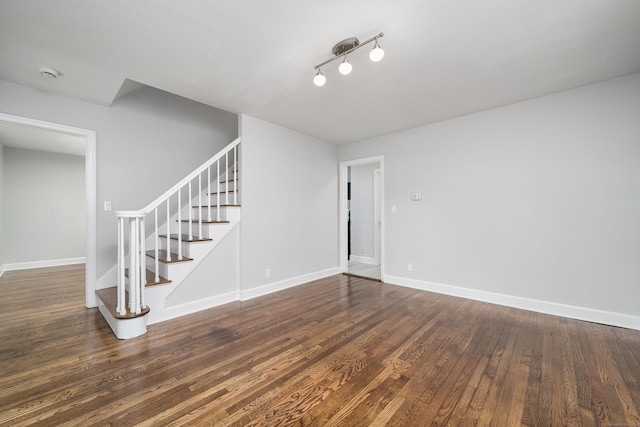 unfurnished living room with dark hardwood / wood-style floors