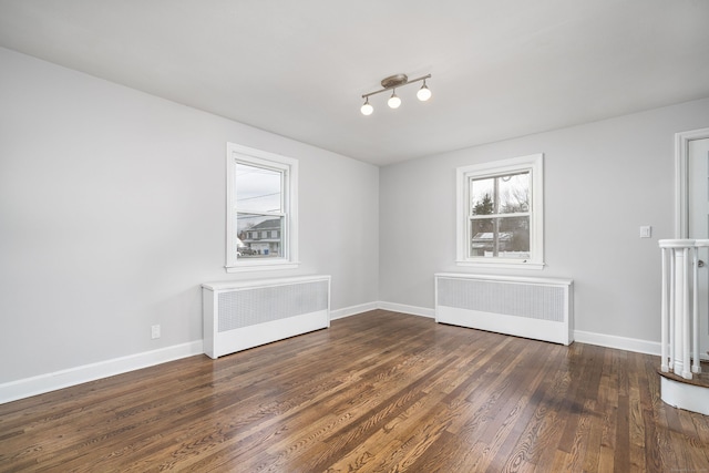 unfurnished dining area with dark hardwood / wood-style floors and radiator heating unit