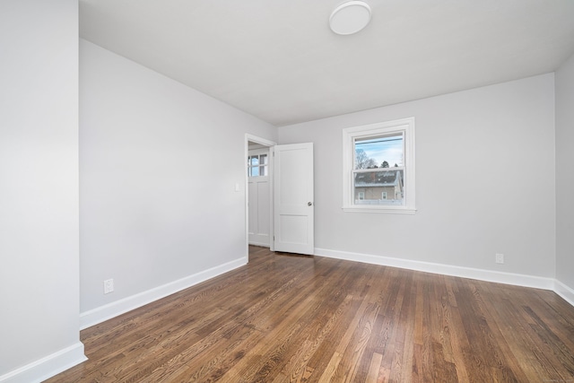 spare room with dark hardwood / wood-style floors