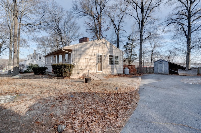 view of property exterior with a storage shed