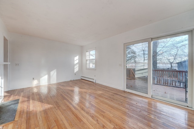 spare room with light hardwood / wood-style flooring and a baseboard radiator