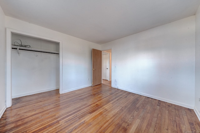 unfurnished bedroom with light hardwood / wood-style floors and a closet