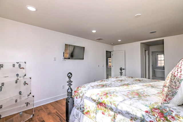 bedroom with dark hardwood / wood-style floors