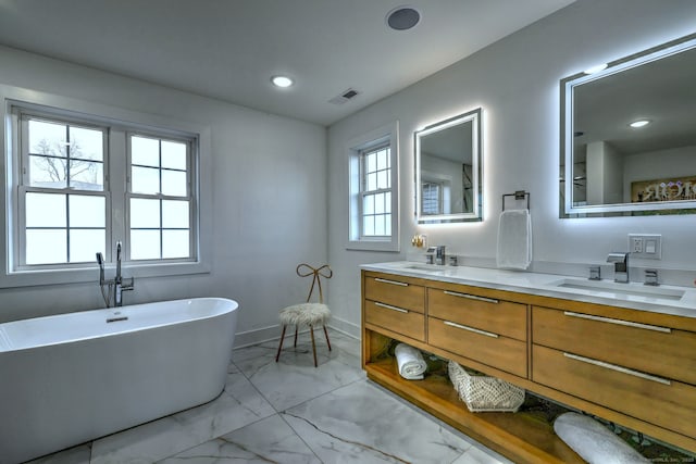 bathroom featuring vanity and a bath