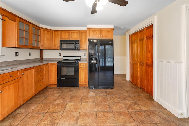 kitchen featuring sink, black appliances, and ceiling fan