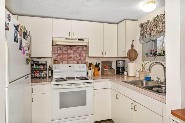 kitchen featuring sink, white appliances, white cabinets, and a textured ceiling