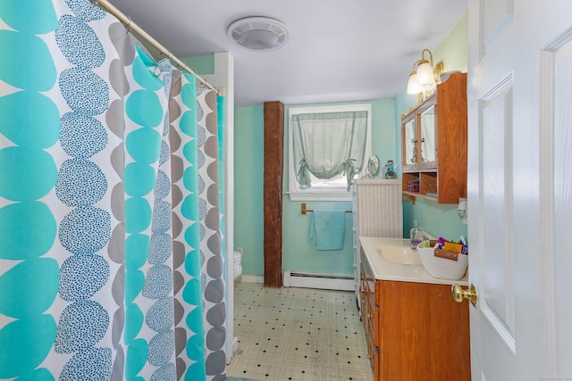 bathroom with vanity, a shower with shower curtain, baseboard heating, and toilet