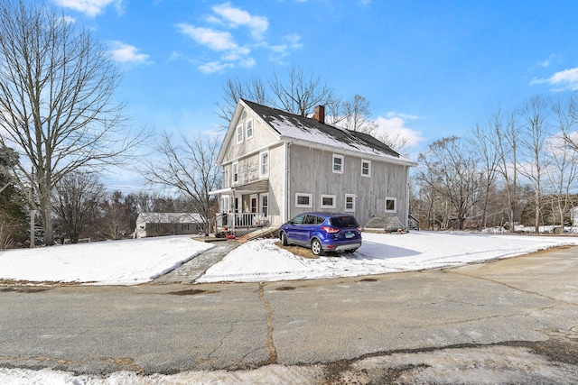 view of snow covered exterior with covered porch