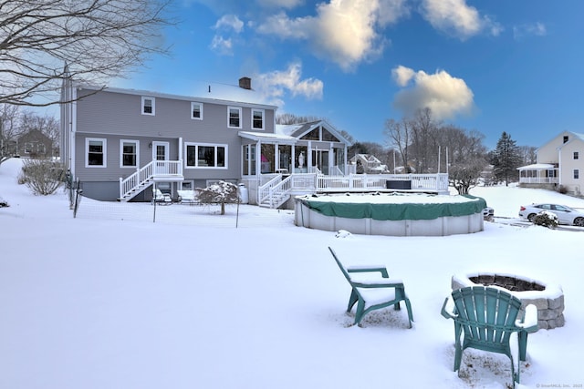 snow covered property featuring a covered pool