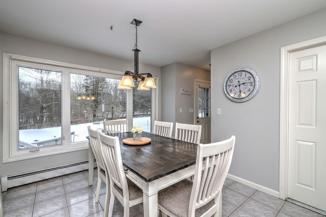 tiled dining space featuring baseboard heating and an inviting chandelier