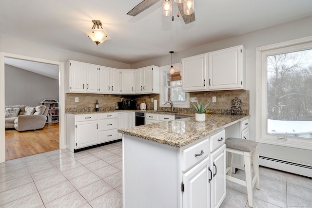 kitchen featuring pendant lighting, white cabinetry, and kitchen peninsula