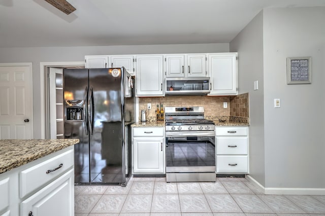 kitchen featuring white cabinets, stainless steel appliances, decorative backsplash, and stone countertops