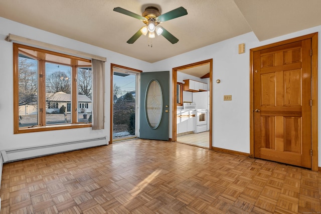 foyer entrance with ceiling fan, light parquet flooring, a textured ceiling, and a baseboard heating unit