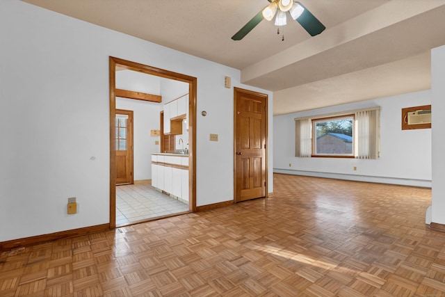 unfurnished living room featuring baseboard heating, sink, light parquet flooring, and a wall mounted air conditioner