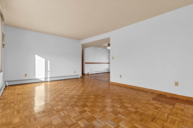 unfurnished room with ceiling fan, light parquet flooring, and a baseboard heating unit