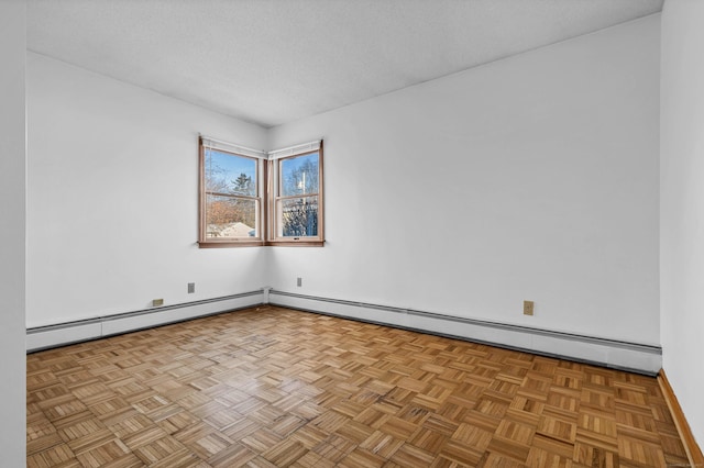 empty room featuring light parquet floors and a textured ceiling