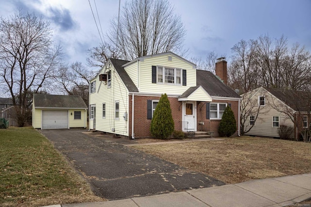 view of front facade featuring a garage and an outbuilding