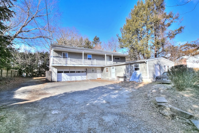 view of front of home with a garage and a balcony