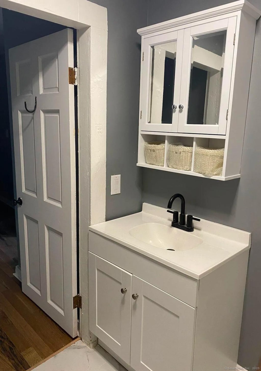 bathroom with hardwood / wood-style flooring and vanity