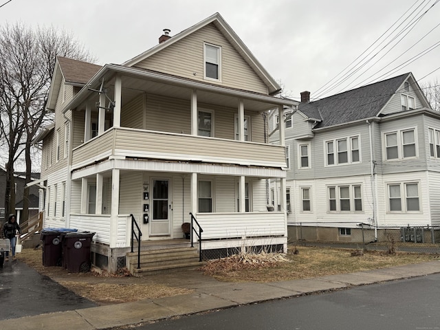 view of front of house with a balcony and a porch