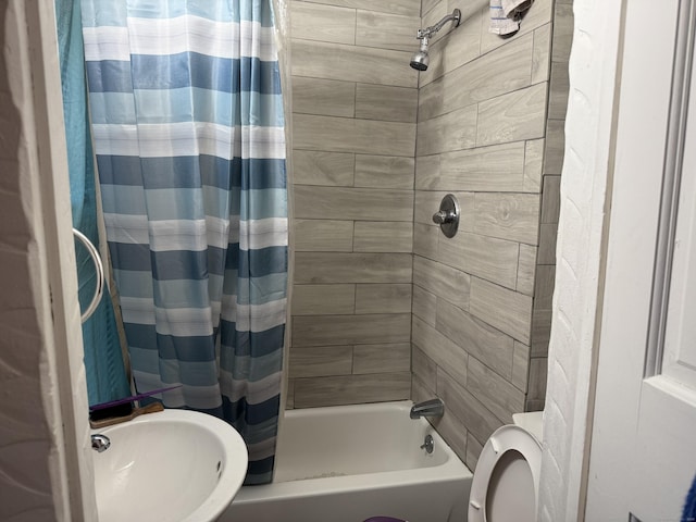 full bathroom with sink, toilet, and shower / bath combination with curtain