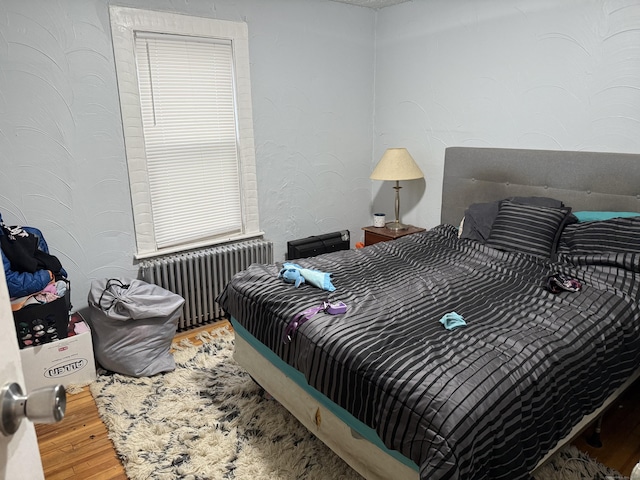 bedroom featuring radiator and wood-type flooring