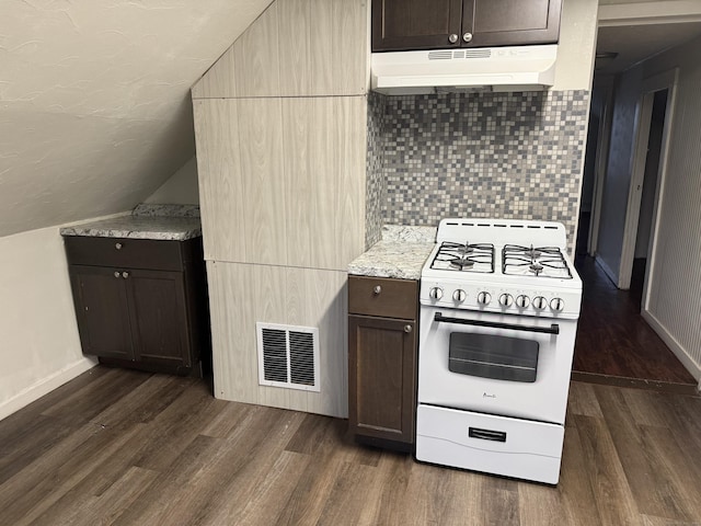 kitchen with dark hardwood / wood-style floors, decorative backsplash, white gas range, dark brown cabinets, and light stone counters