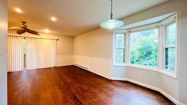 unfurnished room featuring ceiling fan, a baseboard radiator, and dark hardwood / wood-style floors