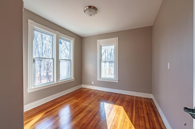 unfurnished room with hardwood / wood-style flooring