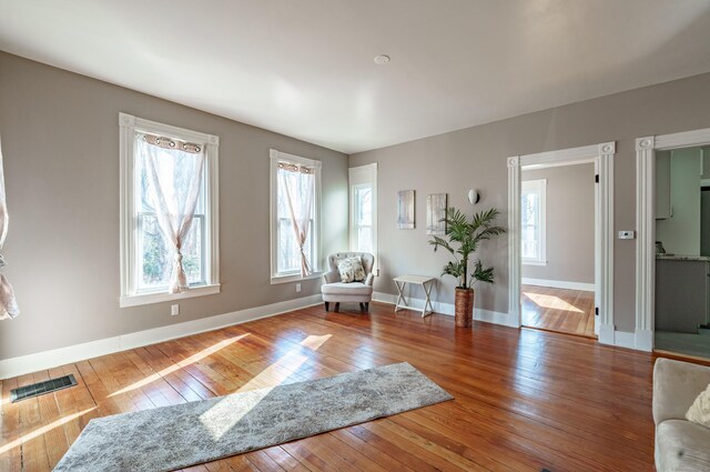 sitting room with hardwood / wood-style flooring