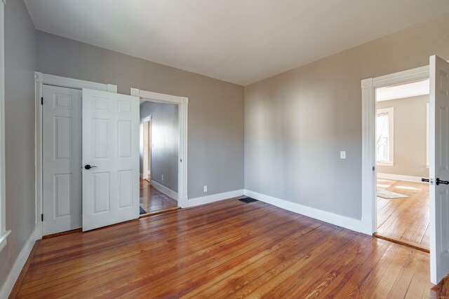 unfurnished bedroom with hardwood / wood-style flooring