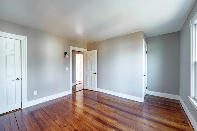 unfurnished bedroom featuring dark hardwood / wood-style floors