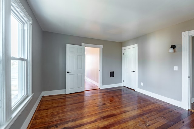 empty room with dark hardwood / wood-style floors