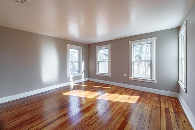 unfurnished room with wood-type flooring