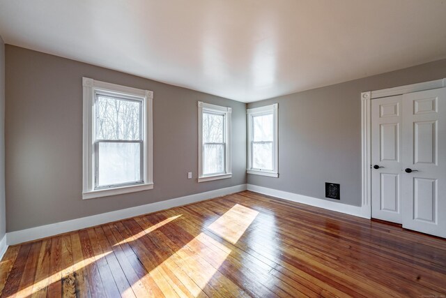 unfurnished room featuring wood-type flooring