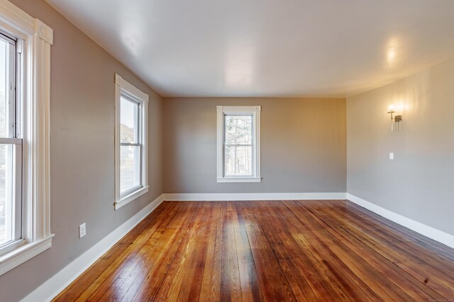 unfurnished room with hardwood / wood-style flooring