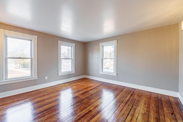 empty room with hardwood / wood-style floors