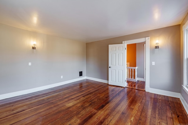 empty room with dark hardwood / wood-style flooring