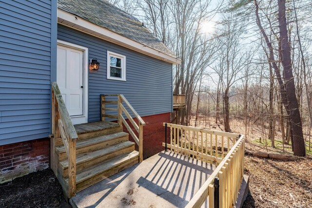 entrance to property featuring a wooden deck