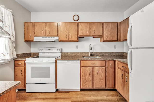 kitchen with sink, white appliances, and light wood-type flooring