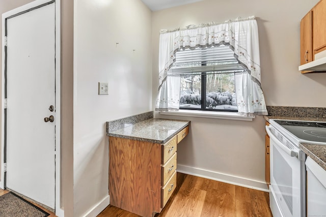 kitchen featuring white electric range and wood-type flooring