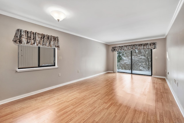 empty room with ornamental molding and light wood-type flooring